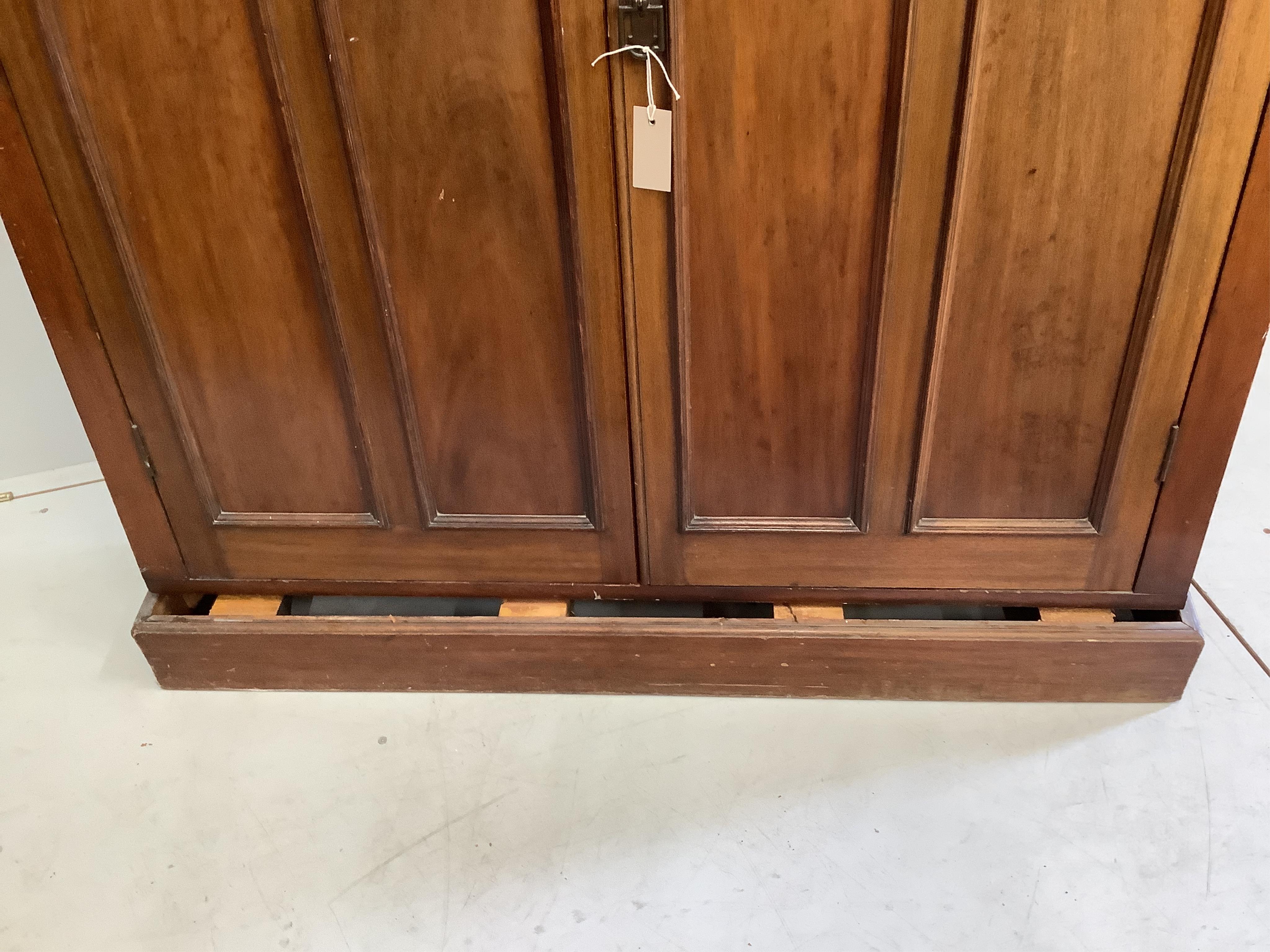An Edwardian mahogany two door side cabinet, (loose plinth), width 124cm, depth 29cm, height 126cm